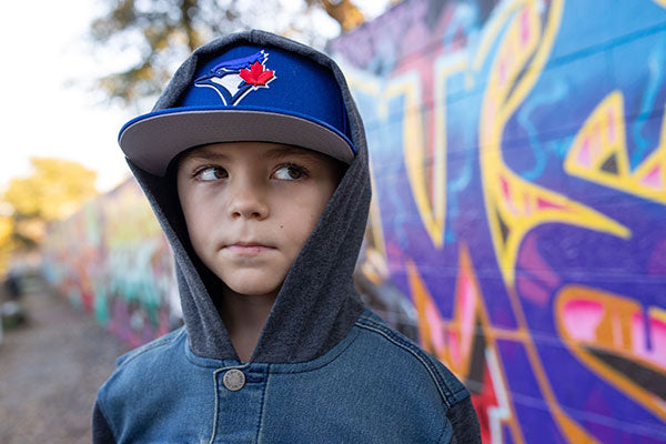 Young boy wearing a cap.