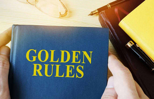 Man holding guide with title golden rules.