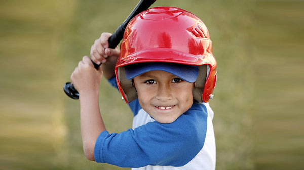 Portrait of Boy with Baseball Bat and Red Helmet