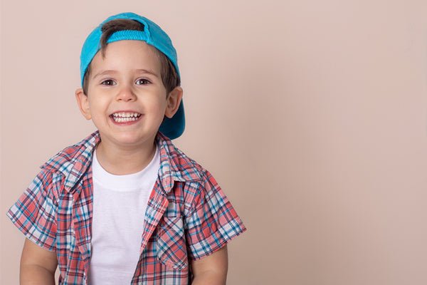 Smiling young boy wearing baseball cap