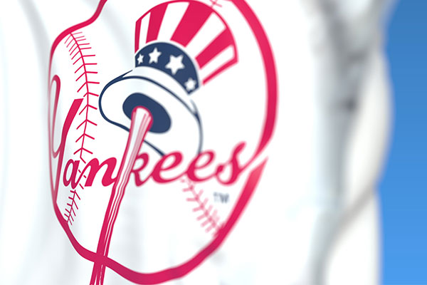 Waving flag with New York Yankees team logo, close-up. Editorial 3D rendering